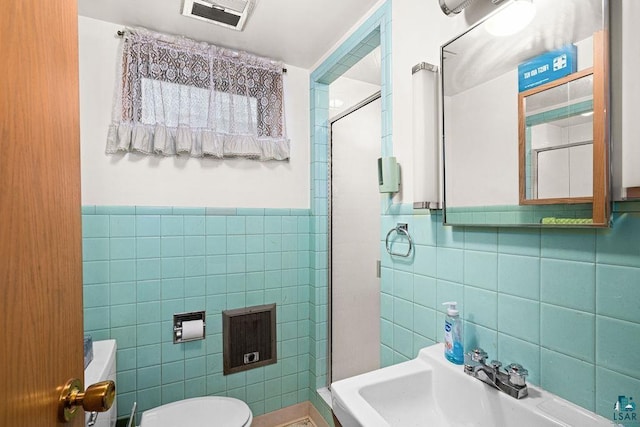 5525 Highland St, Duluth, MN 55807 - bathroom with tile walls, a shower stall, and wainscoting