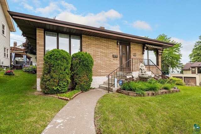 5525 Highland St, Duluth, MN 55807 - view of front of property with brick siding and a front yard