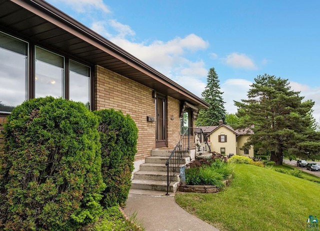 5525 Highland St, Duluth, MN 55807 - property entrance with brick siding and a yard