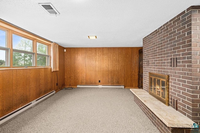 5525 Highland St, Duluth, MN 55807 - unfurnished living room with baseboard heating, wood walls, a brick fireplace, carpet, and a textured ceiling