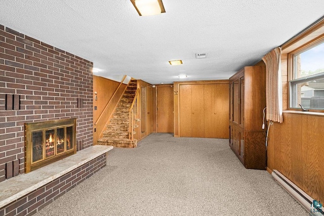 5525 Highland St, Duluth, MN 55807 - unfurnished living room with a baseboard radiator, a textured ceiling, stairway, light carpet, and a brick fireplace