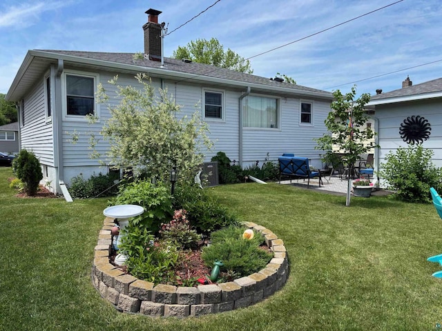 1264 92nd Ave W, Duluth, MN 55808 - back of property with a chimney, a lawn, and a patio area