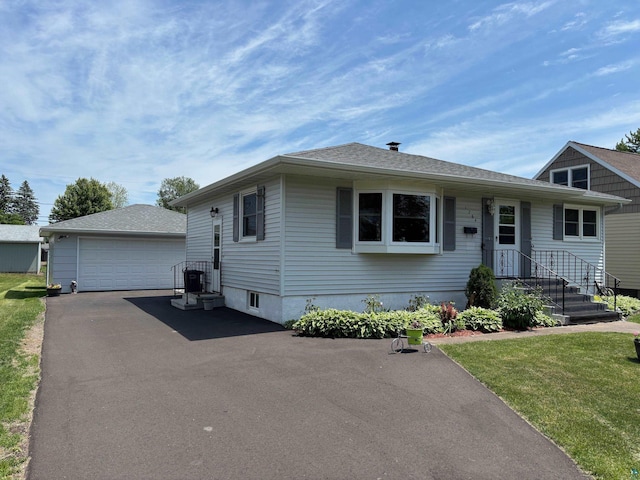 1264 92nd Ave W, Duluth, MN 55808 - view of front facade with an outbuilding, a detached garage, and a front yard