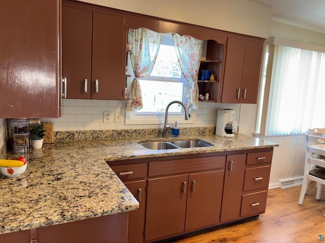 1264 92nd Ave W, Duluth, MN 55808 - kitchen with backsplash, light wood-style floors, open shelves, and light stone counters