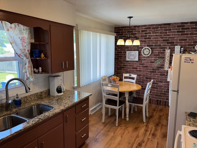 1264 92nd Ave W, Duluth, MN 55808 - kitchen featuring freestanding refrigerator, range, brick wall, light wood-type flooring, and open shelves