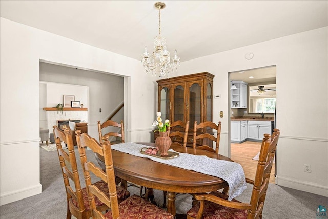2807 E 2nd St, Duluth, MN 55812 - dining space with light carpet, a chandelier, and a ceiling fan