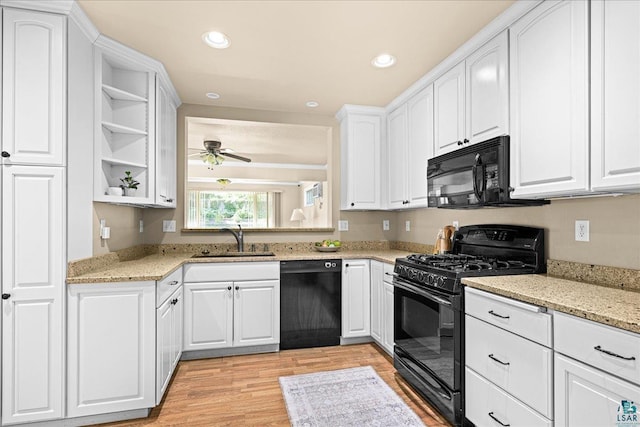 2807 E 2nd St, Duluth, MN 55812 - kitchen featuring black appliances, open shelves, light wood-type flooring, ceiling fan, and white cabinetry