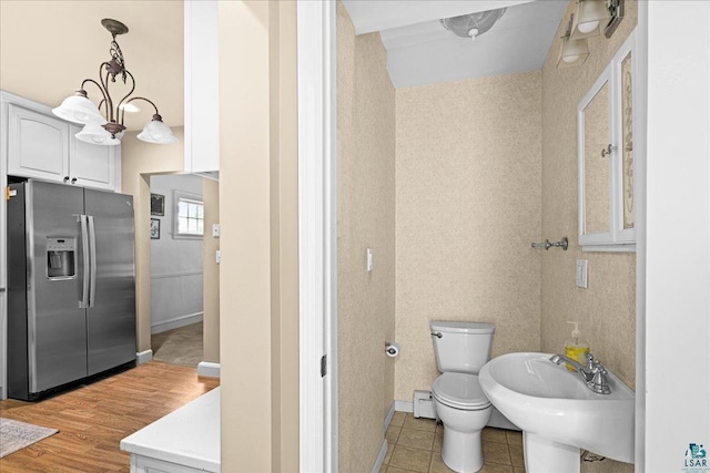 2807 E 2nd St, Duluth, MN 55812 - bathroom with a baseboard radiator and wood finished floors