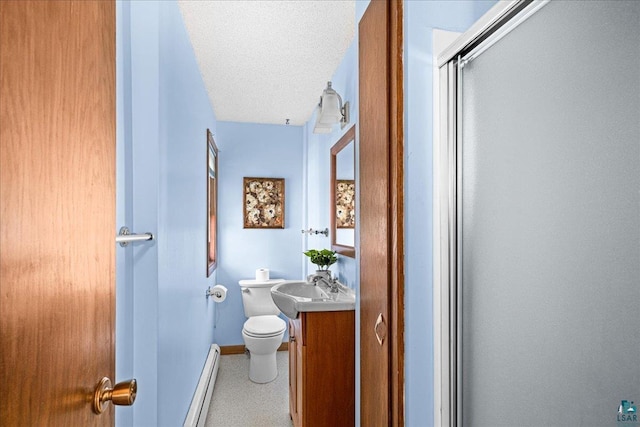 2807 E 2nd St, Duluth, MN 55812 - bathroom featuring a baseboard radiator, vanity, speckled floor, a shower with door, and a textured ceiling