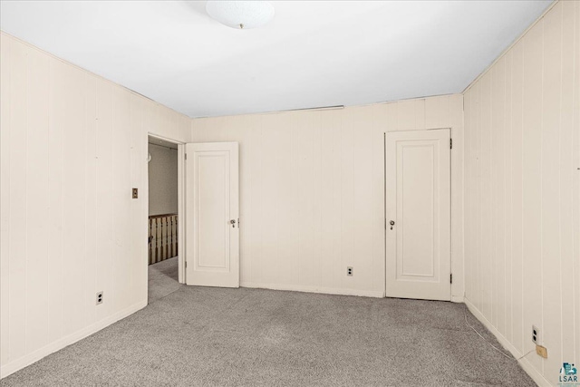 2807 E 2nd St, Duluth, MN 55812 - spare room with carpet floors and wooden walls