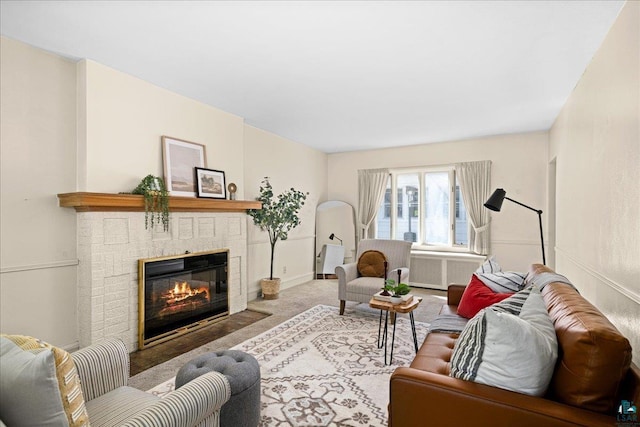 2807 E 2nd St, Duluth, MN 55812 - carpeted living room featuring a brick fireplace and radiator heating unit