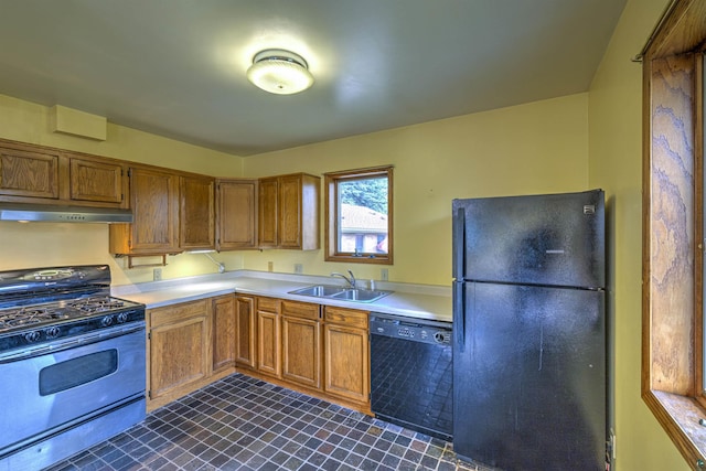 4128 Gladstone St, Duluth, MN 55804 - kitchen with black appliances, under cabinet range hood, light countertops, and brown cabinets