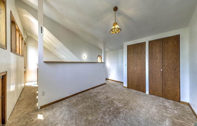 4128 Gladstone St, Duluth, MN 55804 - unfurnished bedroom with carpet, multiple closets, and vaulted ceiling