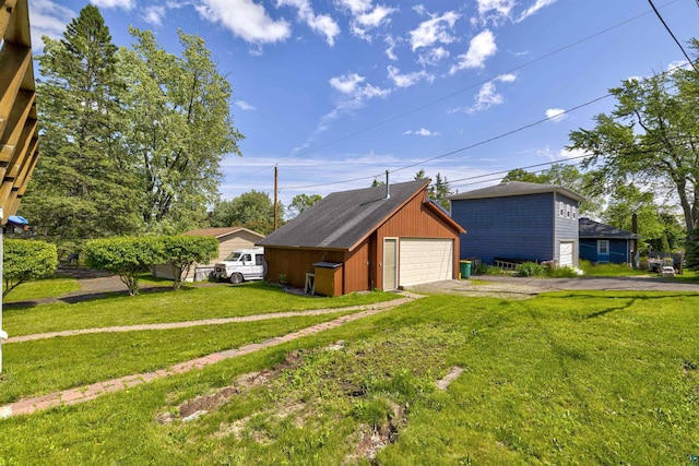 4128 Gladstone St, Duluth, MN 55804 - view of home's exterior featuring a garage, an outdoor structure, and a lawn