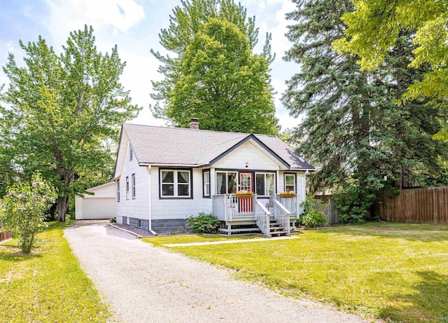 136 W Winona St, Duluth, MN 55803 - view of front of home with a chimney, a shingled roof, an outbuilding, and a detached garage
