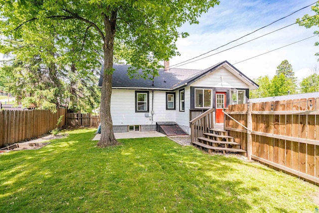 136 W Winona St, Duluth, MN 55803 - back of property with a fenced backyard, a shingled roof, and a chimney