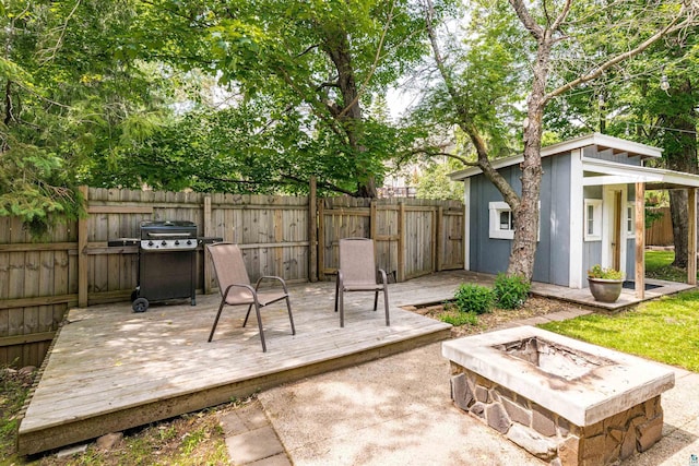 136 W Winona St, Duluth, MN 55803 - fenced backyard featuring an outdoor fire pit, an outbuilding, and a wooden deck