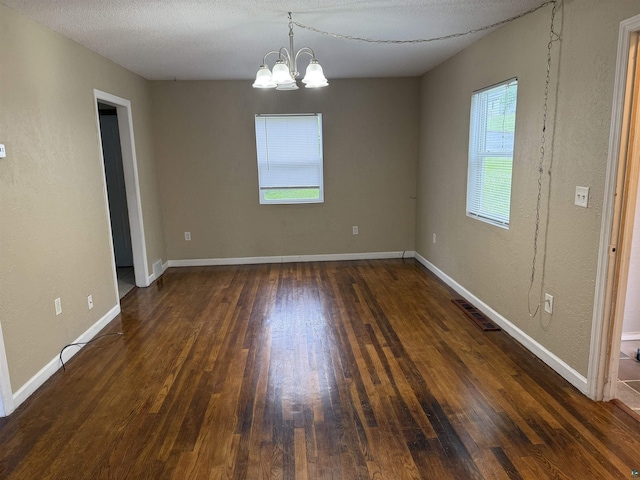 812 Allen St, Cloquet, MN 55720 - empty room with dark wood-type flooring and a chandelier