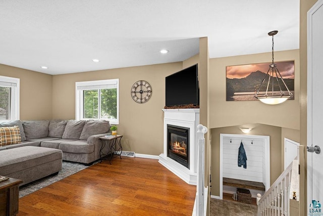 1207 Jean Marie St, Cloquet, MN 55720 - living area featuring wood finished floors, a glass covered fireplace, and recessed lighting