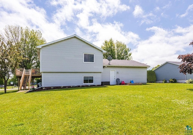 1207 Jean Marie St, Cloquet, MN 55720 - rear view of property with stairs, a deck, and a lawn