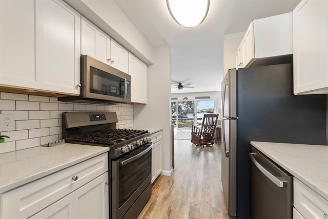 524 Marina Dr Unit 524, Superior, WI 54880 - kitchen with stainless steel appliances, white cabinetry, light wood finished floors, and a ceiling fan