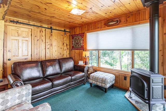14575 Jackpine Trl, Ely, MN 55731 - living room featuring a wood stove, wooden walls, carpet, wood ceiling, and a barn door