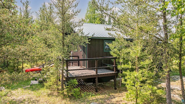 14575 Jackpine Trl, Ely, MN 55731 - rear view of house featuring a wooden deck and a metal roof
