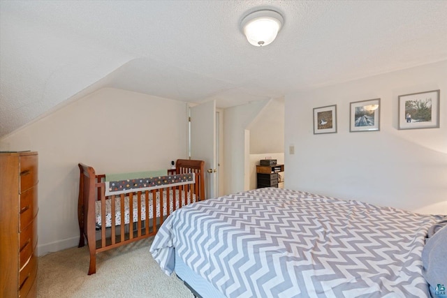 2323 Catskill St, Duluth, MN 55811 - bedroom with carpet floors, vaulted ceiling, and a textured ceiling