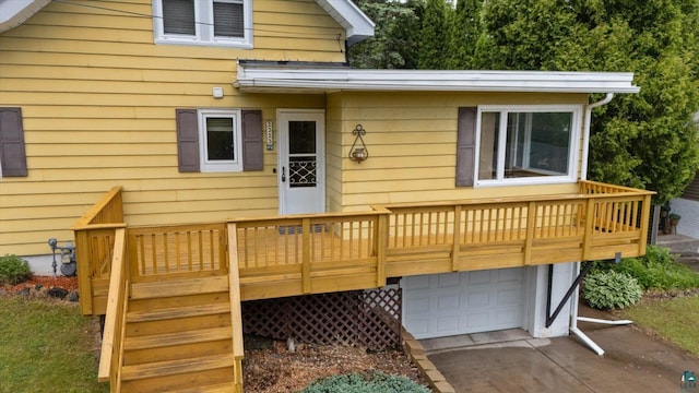 2323 Catskill St, Duluth, MN 55811 - rear view of house featuring a garage, a deck, and asphalt driveway