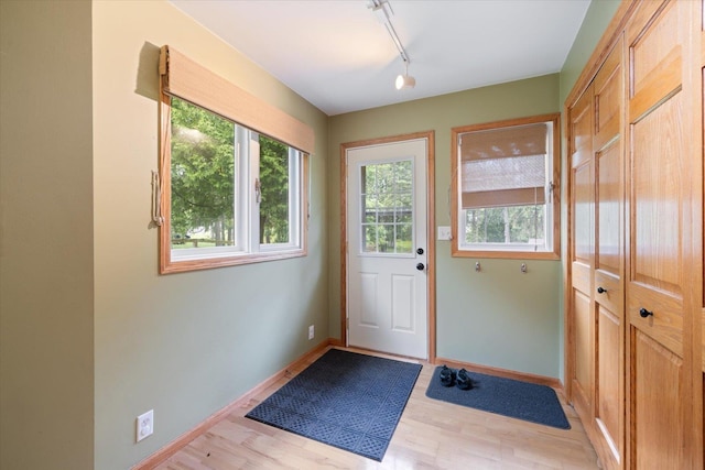 2323 Catskill St, Duluth, MN 55811 - doorway to outside featuring healthy amount of natural light, light wood finished floors, and rail lighting