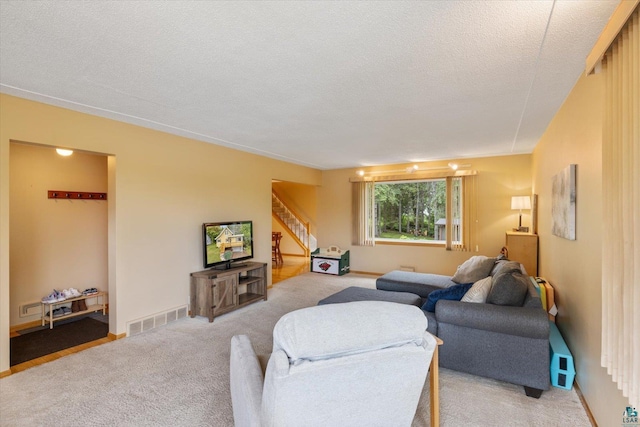2323 Catskill St, Duluth, MN 55811 - living room with stairs, light colored carpet, and a textured ceiling