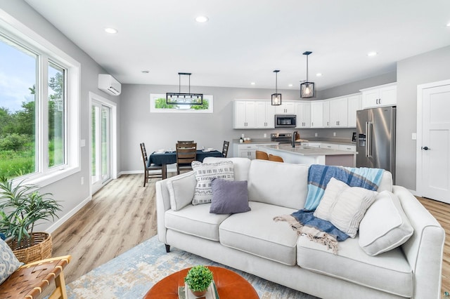 5122 Hermantown Rd Unit 5122, Hermantown, MN 55810 - living room with a wall mounted AC, recessed lighting, plenty of natural light, and light wood-style flooring