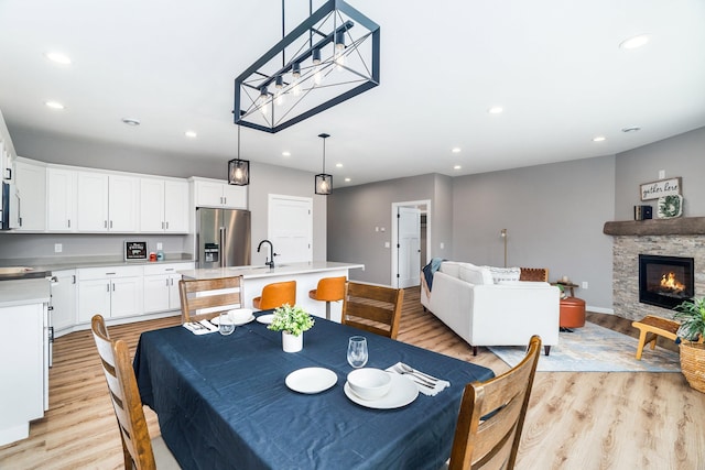 5122 Hermantown Rd Unit 5122, Hermantown, MN 55810 - dining space with light wood-type flooring, recessed lighting, and a fireplace