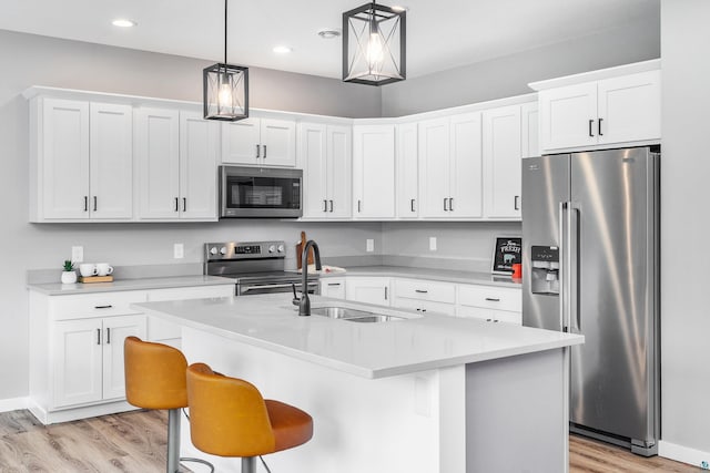 5122 Hermantown Rd Unit 5122, Hermantown, MN 55810 - kitchen with appliances with stainless steel finishes, light wood-style floors, light countertops, pendant lighting, and white cabinets