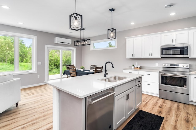 5122 Hermantown Rd Unit 5122, Hermantown, MN 55810 - kitchen featuring appliances with stainless steel finishes, a wall mounted air conditioner, light countertops, healthy amount of natural light, and recessed lighting