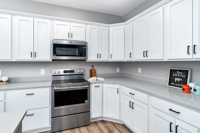5122 Hermantown Rd Unit 5122, Hermantown, MN 55810 - kitchen with stainless steel appliances, light countertops, white cabinetry, and light wood-style floors