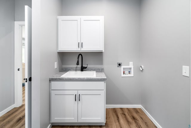 5122 Hermantown Rd Unit 5122, Hermantown, MN 55810 - laundry area featuring wood finished floors, electric dryer hookup, hookup for a washing machine, and cabinet space