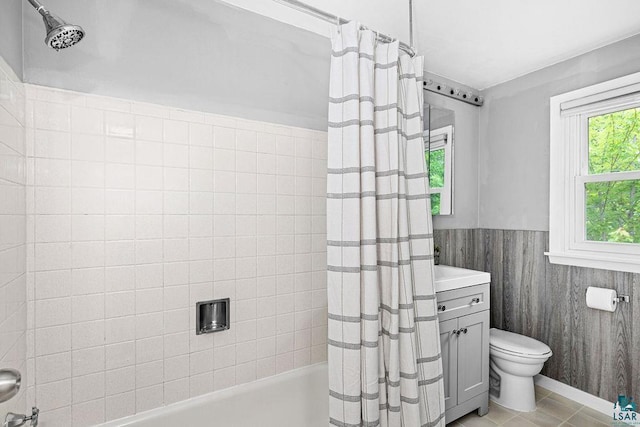 137 Madison Ave Unit 137, Duluth, MN 55811 - bathroom featuring shower / tub combo with curtain, wainscoting, vanity, and tile patterned flooring
