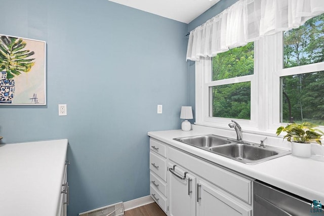 137 Madison Ave Unit 137, Duluth, MN 55811 - kitchen with dishwasher, white cabinetry, light countertops, and dark wood-style floors