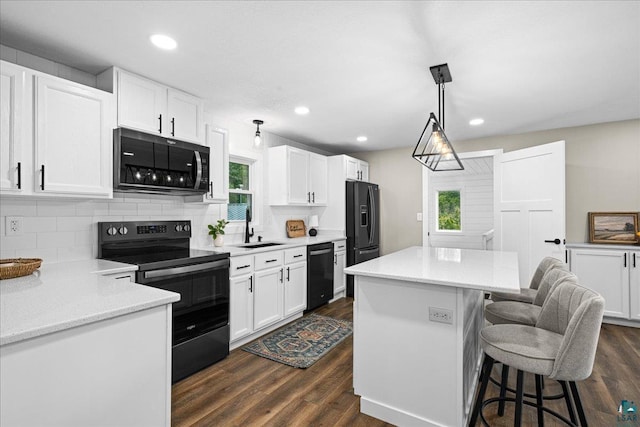 4414 Midway Rd, Hermantown, MN 55811 - kitchen featuring black appliances, dark wood finished floors, a kitchen island, backsplash, and recessed lighting
