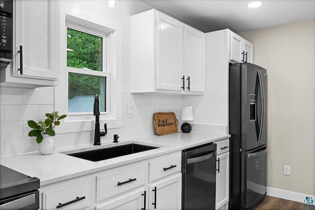 4414 Midway Rd, Hermantown, MN 55811 - kitchen with black refrigerator with ice dispenser, dishwasher, white cabinetry, decorative backsplash, and recessed lighting