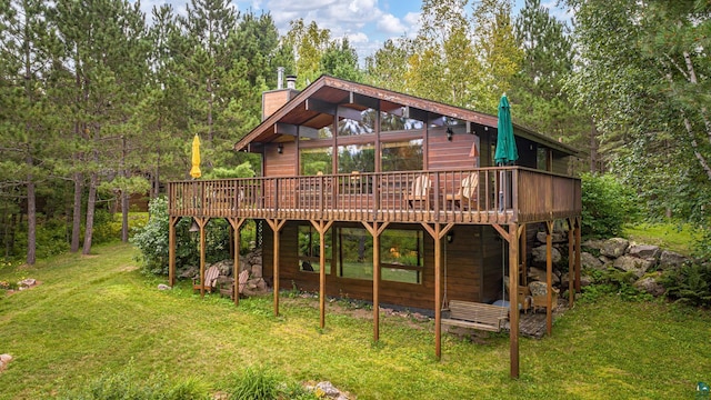 3206 Shady Rst, Ely, MN 55731 - back of house with a deck, a lawn, and a chimney