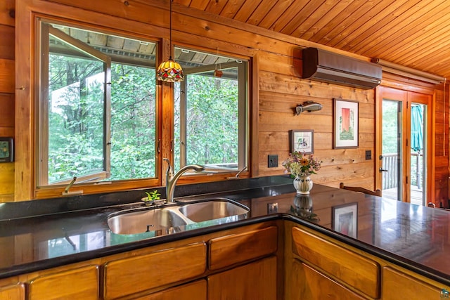 3206 Shady Rst, Ely, MN 55731 - kitchen featuring an AC wall unit, wood ceiling, wooden walls, and brown cabinetry