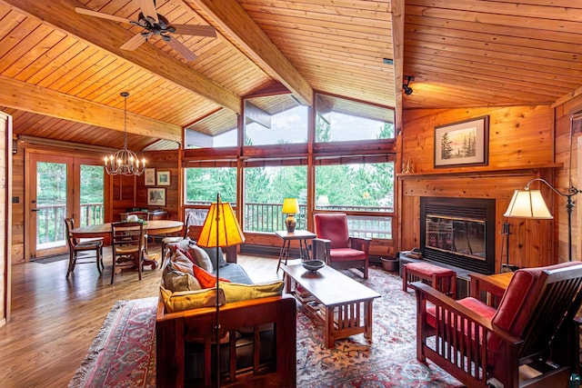 3206 Shady Rst, Ely, MN 55731 - living area featuring a chandelier, wooden walls, a glass covered fireplace, wood finished floors, and wooden ceiling