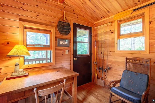 3206 Shady Rst, Ely, MN 55731 - dining room featuring vaulted ceiling, healthy amount of natural light, wood finished floors, wood walls, and wooden ceiling