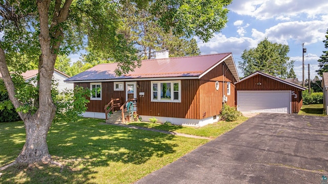 53 Dogwood Blvd, Babbitt, MN 55706 - ranch-style house featuring a garage, an outbuilding, a metal roof, a front lawn, and a chimney