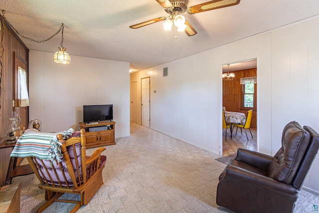 53 Dogwood Blvd, Babbitt, MN 55706 - living area with a ceiling fan, a chandelier, a textured ceiling, and light carpet