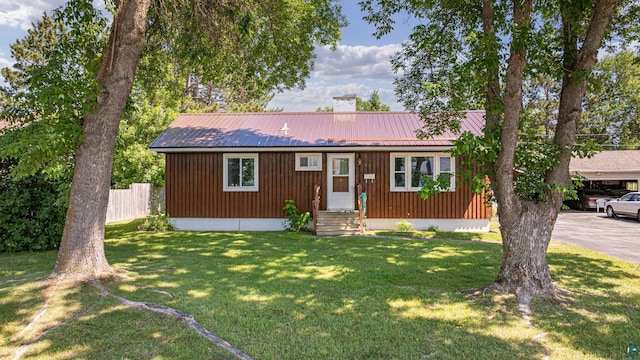 53 Dogwood Blvd, Babbitt, MN 55706 - view of front of property featuring a chimney, entry steps, a front yard, and a metal roof
