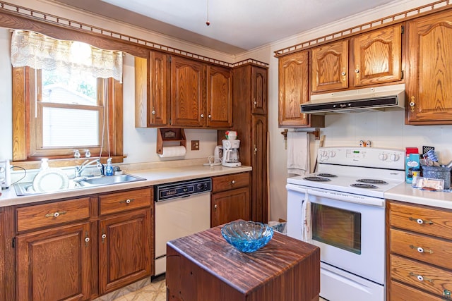53 Dogwood Blvd, Babbitt, MN 55706 - kitchen with white appliances, under cabinet range hood, brown cabinets, and light countertops