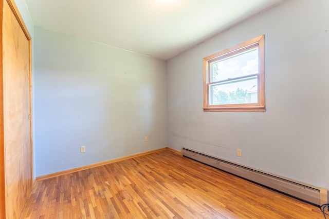 8702 Sock Lake Rd, Babbitt, MN 55706 - spare room with a baseboard heating unit and light wood-type flooring